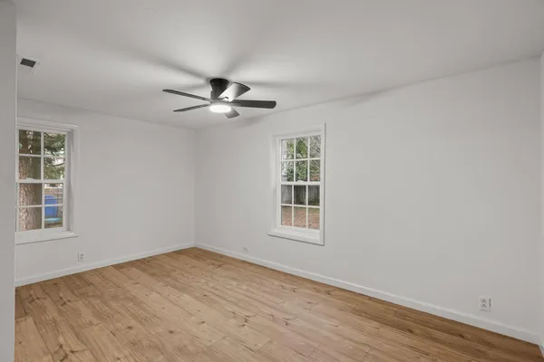 wooden floor in an empty room with a window