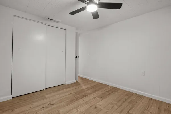 a view of an empty room with wooden floor