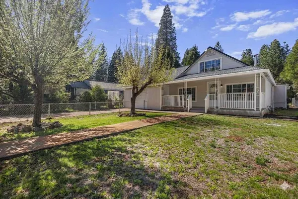 a view of a house with swimming pool and a yard