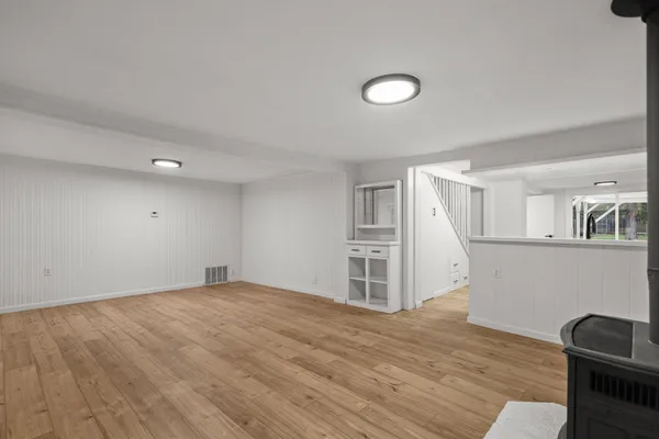 a view of empty room with wooden floor