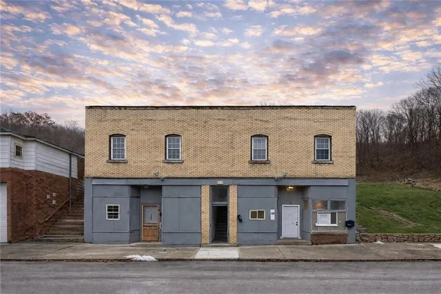 a front view of a house with yard
