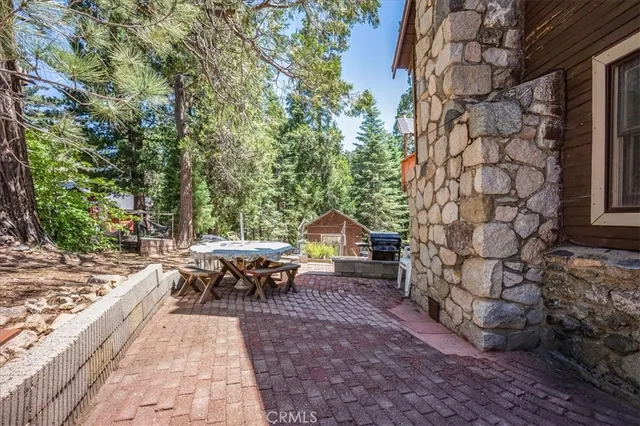 a view of a patio with table and chairs and couches with wooden floor and fence