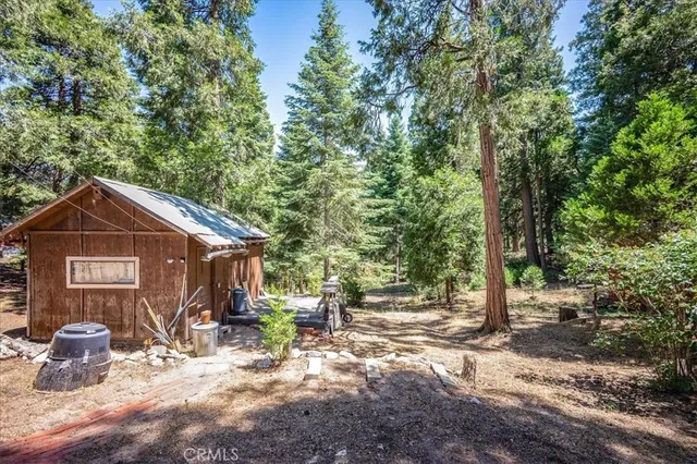 a view of a small house with yard and trampoline