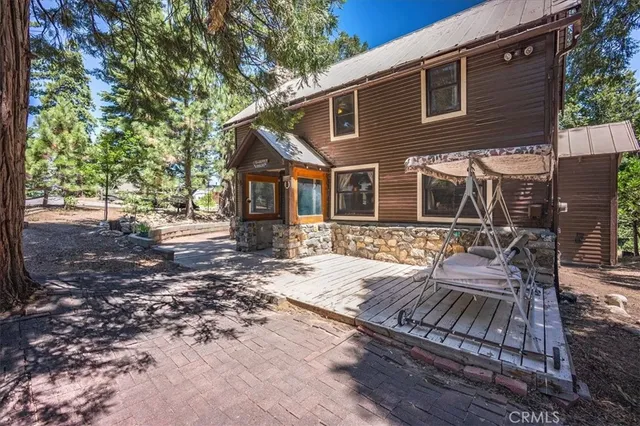a front view of a house with garden and patio