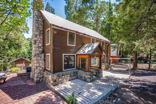 a view of a house with a yard balcony and furniture