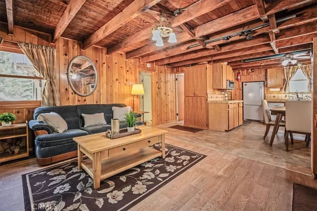 a living room with furniture a wooden floor and next to a window