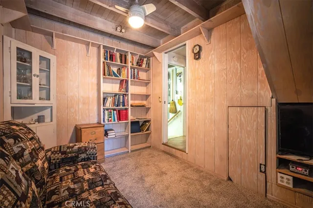 a view of a livingroom with furniture and an empty room
