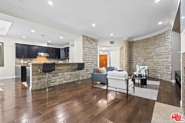 a kitchen with stainless steel appliances kitchen island granite countertop a sink and a stove