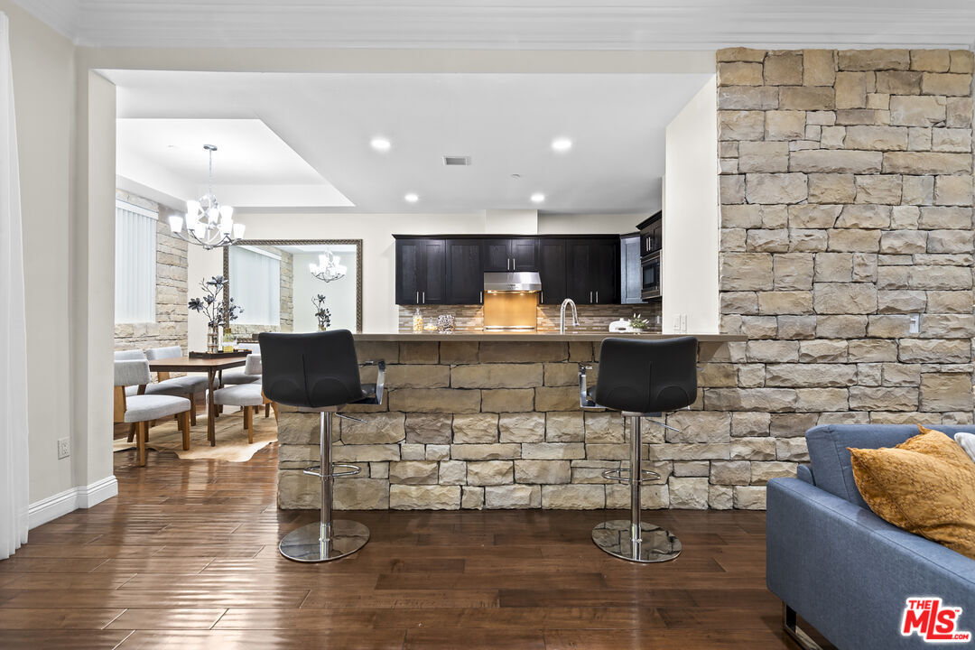 4848 Wilshire Boulevard, Unit 102 Los Angeles, CA 90036 - Photo 17 of 47 a kitchen with stainless steel appliances kitchen island granite countertop a sink and a stove