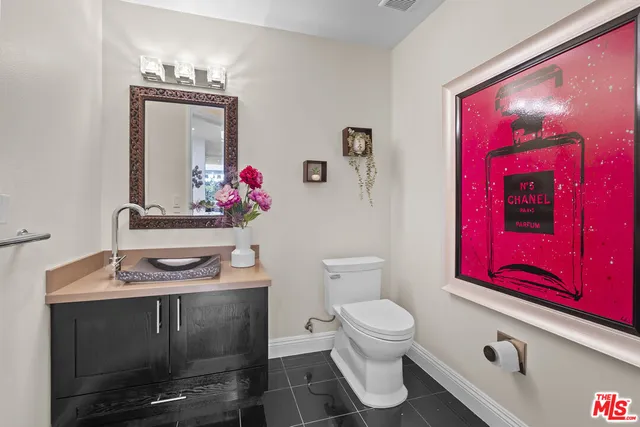 a kitchen with stainless steel appliances granite countertop wooden cabinets a stove top oven and granite counter tops