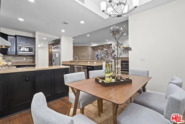 a view of a dining room with furniture and chandelier