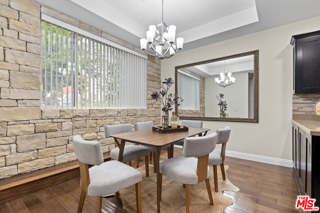 4848 Wilshire Boulevard, Unit 102 Los Angeles, CA 90036 - Photo 23 of 47 a view of a dining room with furniture and chandelier