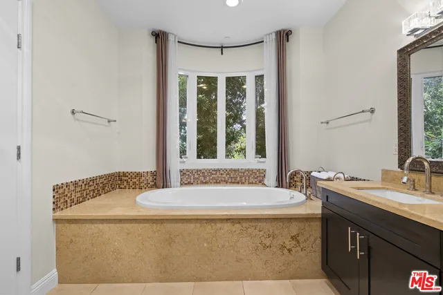 a view of a kitchen with wooden floor and cabinets