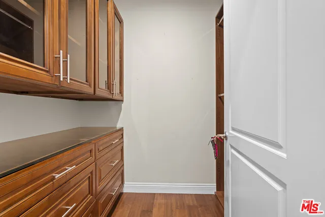 a spacious bedroom with a bed and wooden floor