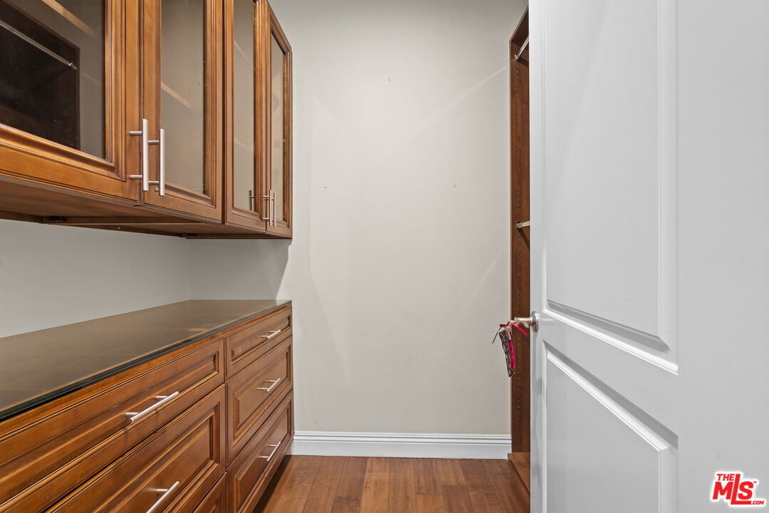 4848 Wilshire Boulevard, Unit 102 Los Angeles, CA 90036 - Photo 31 of 47 a view of a kitchen with wooden floor and cabinets