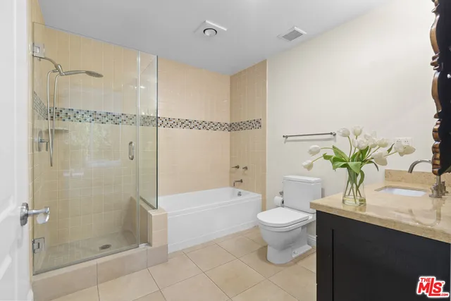 a bedroom with bed and a night stand