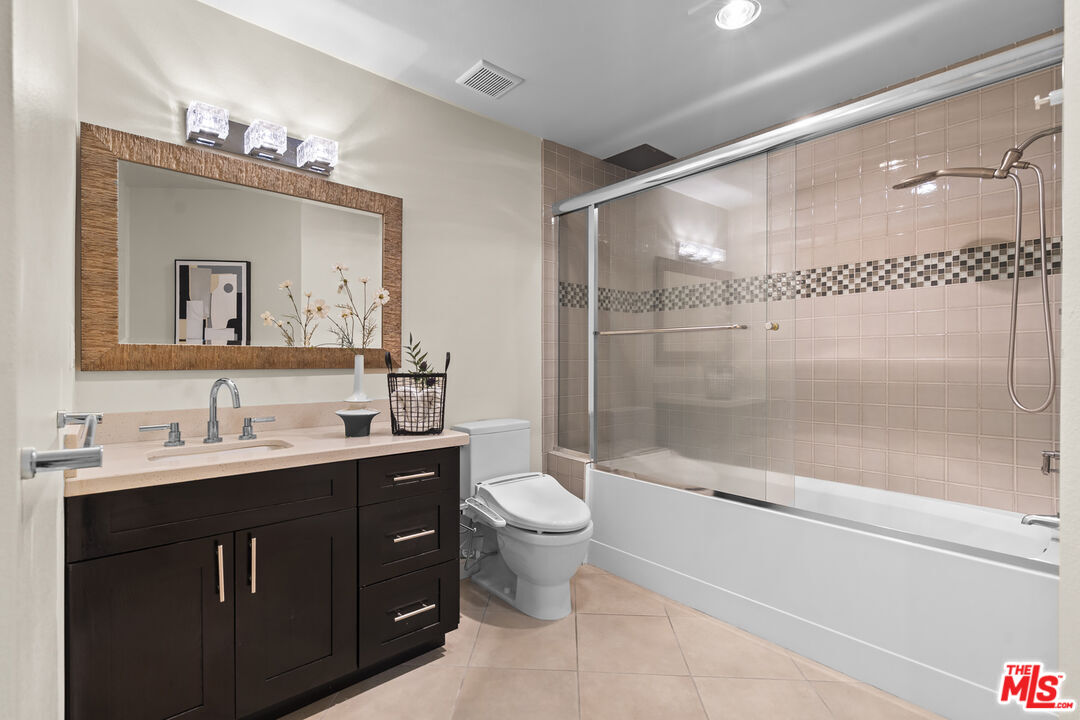 4848 Wilshire Boulevard, Unit 102 Los Angeles, CA 90036 - Photo 42 of 47 a bathroom with a double vanity sink mirror and toilet