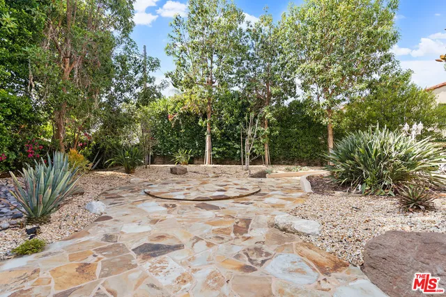 a living room with fireplace furniture and a large window