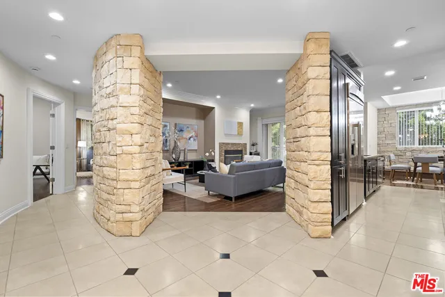 a living room with furniture a rug and a fireplace