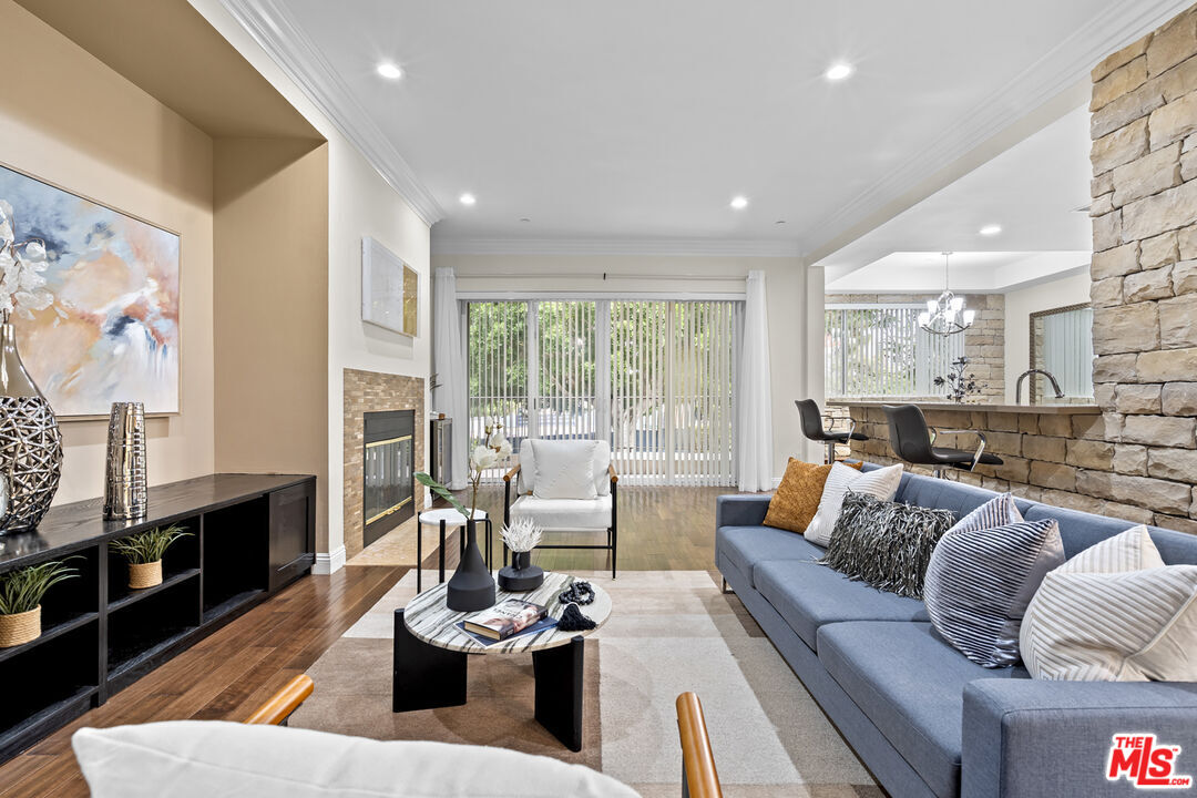4848 Wilshire Boulevard, Unit 102 Los Angeles, CA 90036 - Photo 10 of 47 a living room with furniture and a flat screen tv