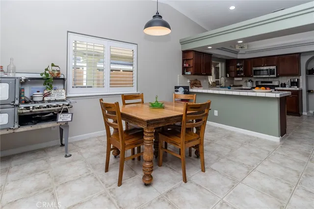 a dining area with furniture and window