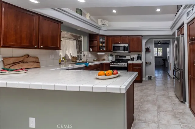 a kitchen with sink a stove and cabinets