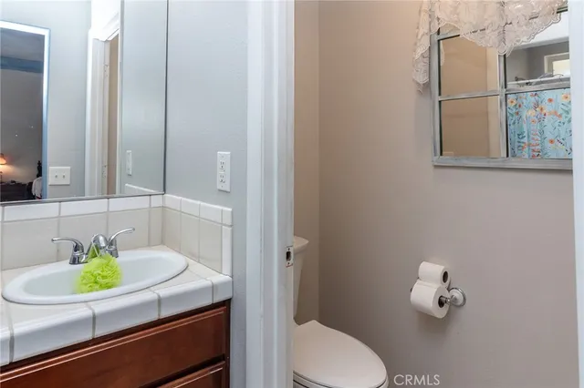 a bathroom with a sink toilet and mirror