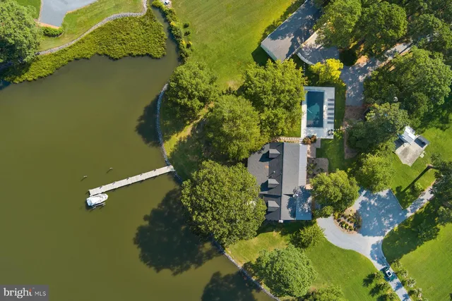 an aerial view of a house with swimming pool and outdoor space