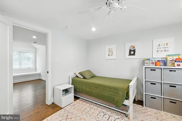 a bedroom with a bed and a mirror