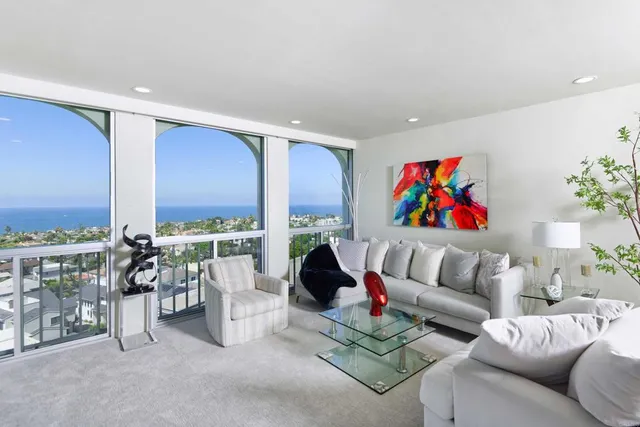 a living room with furniture and a floor to ceiling window