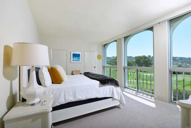 a bedroom with a bed and large window