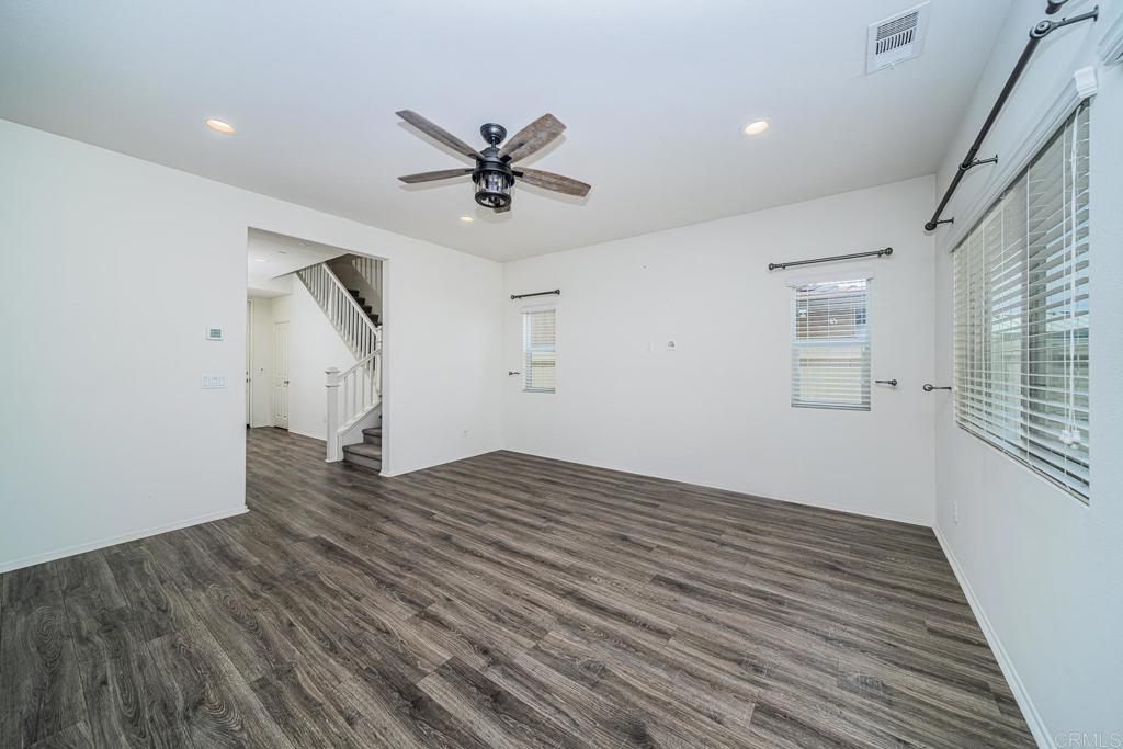 340 Falabella Lane Fallbrook, CA 92028 - Photo 14 of 63 a view of empty room with wooden floor and ceiling fan