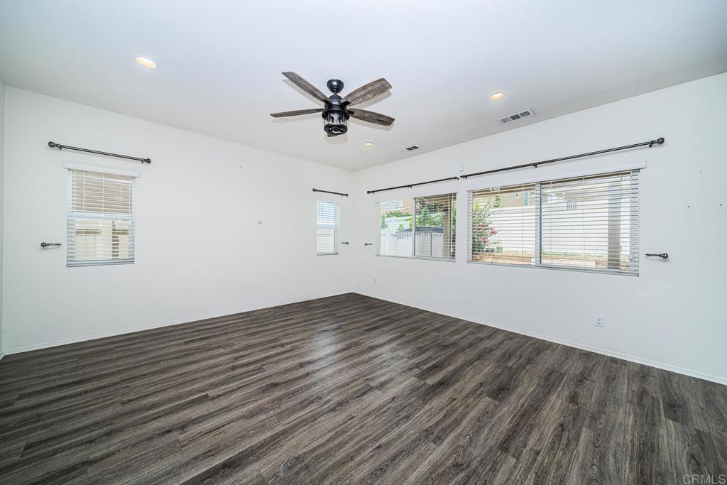 340 Falabella Lane Fallbrook, CA 92028 - Photo 15 of 63 a view of empty room with wooden floor and fan