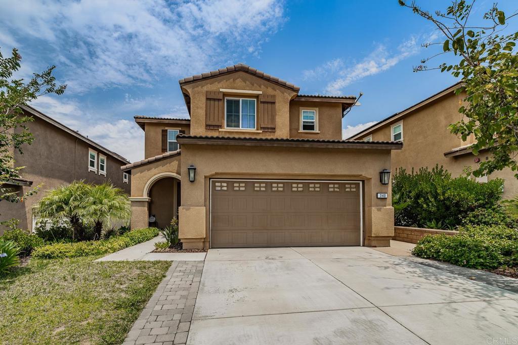 340 Falabella Lane Fallbrook, CA 92028 - Photo 2 of 63 a front view of a house with a yard and garage