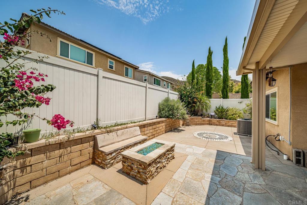 340 Falabella Lane Fallbrook, CA 92028 - Photo 29 of 63 a backyard of a house with flower plants and wooden fence