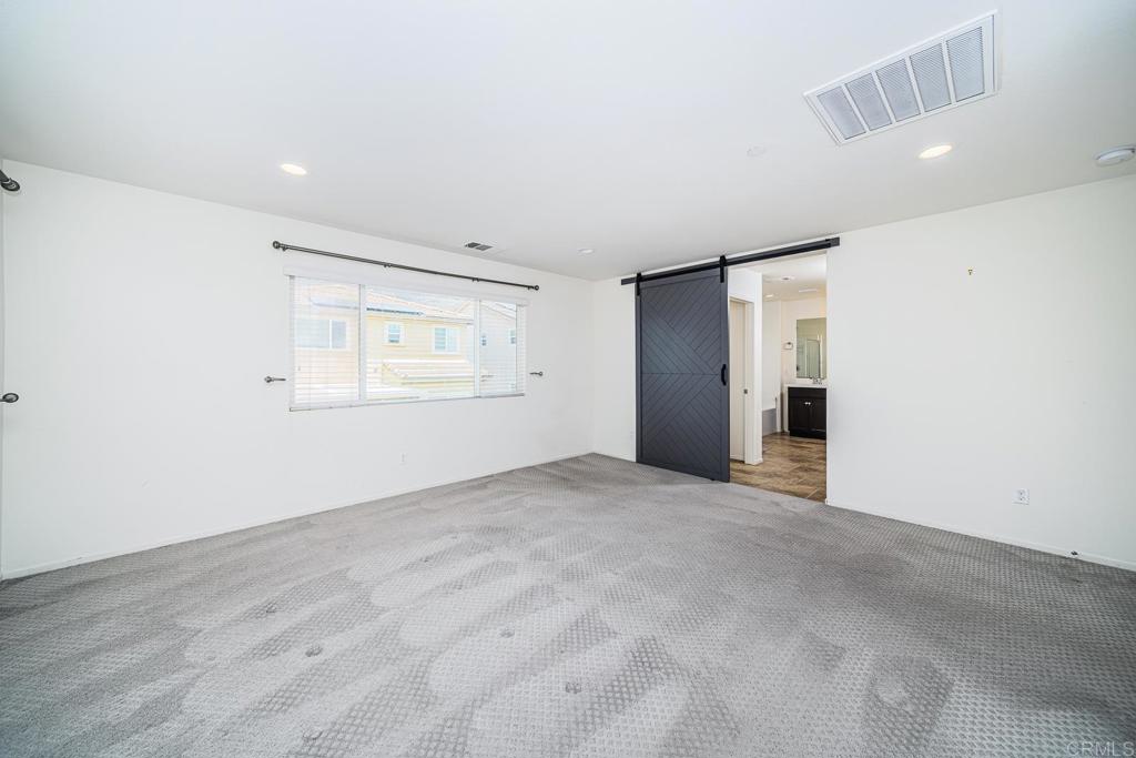 340 Falabella Lane Fallbrook, CA 92028 - Photo 33 of 63 an empty room with windows and refrigerator