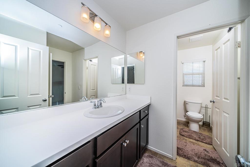 340 Falabella Lane Fallbrook, CA 92028 - Photo 41 of 63 a bathroom with a sink a toilet and a mirror
