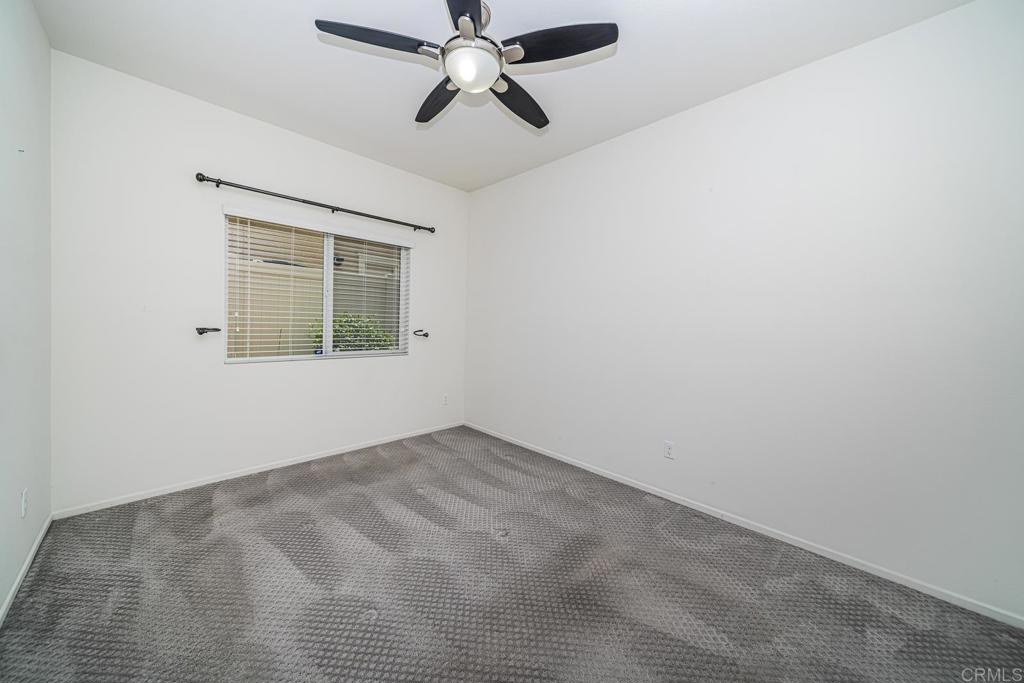 340 Falabella Lane Fallbrook, CA 92028 - Photo 10 of 63 an empty room with a window and a fan