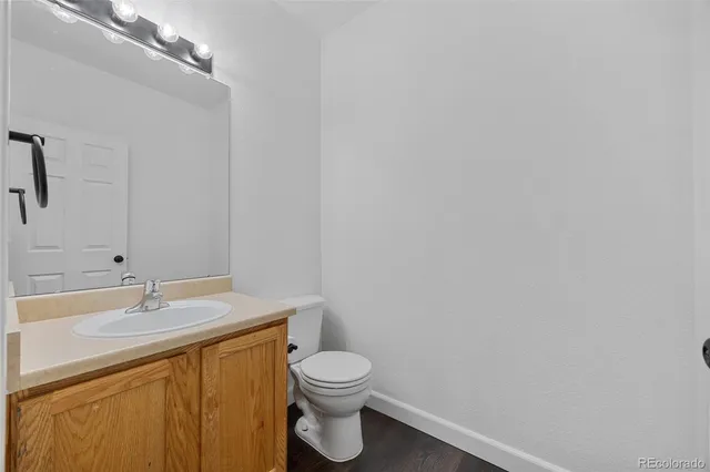 a bathroom with a sink a toilet and vanity