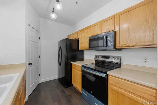 a kitchen with stainless steel appliances granite countertop a stove a refrigerator and a microwave