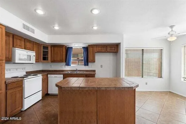 a kitchen with a stove sink and cabinets
