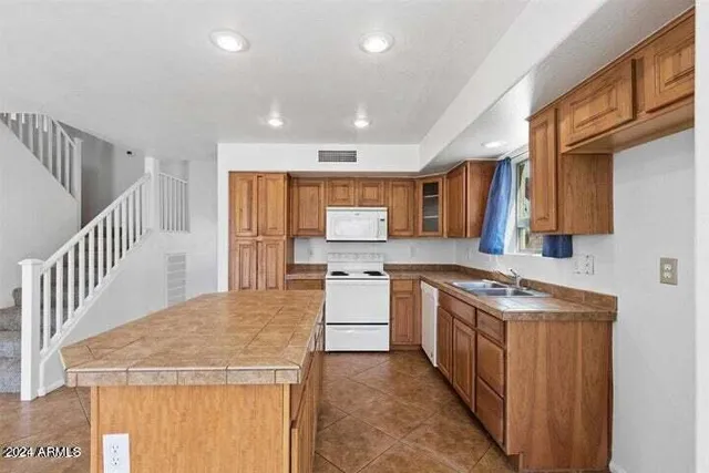 a view of a kitchen with furniture and wooden floor