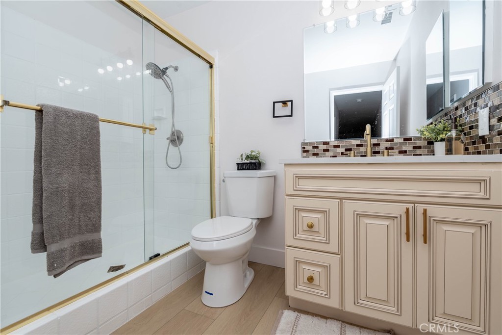 16066 Rancho Verde Circle Riverside, CA 92506 - Photo 18 of 29 a bathroom with a sink toilet a mirror and shower