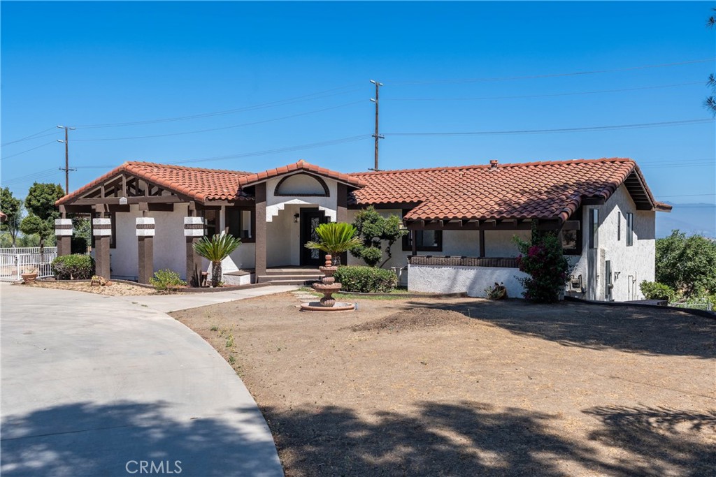 16066 Rancho Verde Circle Riverside, CA 92506 - Photo 2 of 29 a front view of a house with a garden