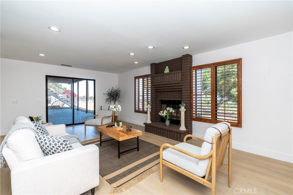 16066 Rancho Verde Circle Riverside, CA 92506 - Photo 23 of 29 a living room with furniture and a fireplace