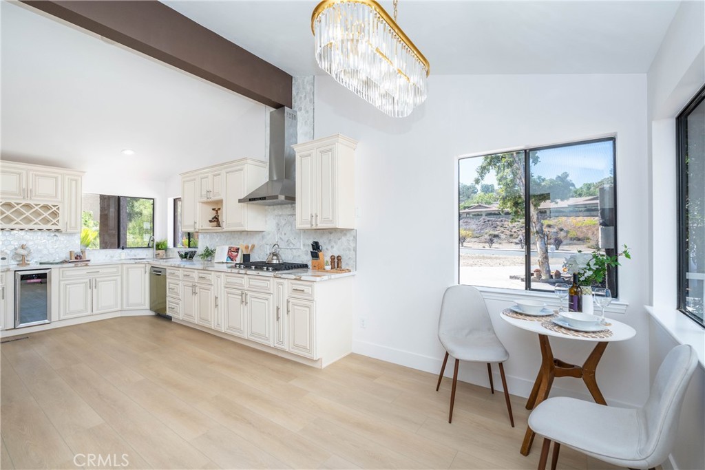16066 Rancho Verde Circle Riverside, CA 92506 - Photo 9 of 29 a kitchen with granite countertop a stove a table and chairs in it