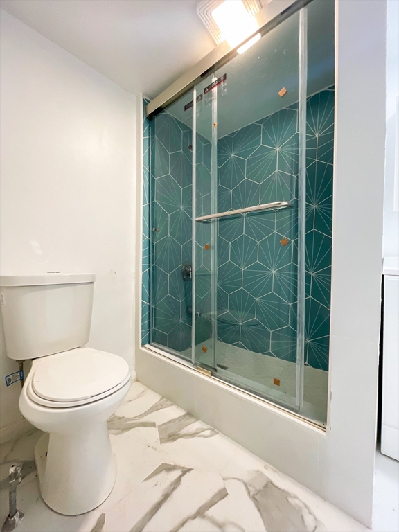 904 Main, Unit 1 Woburn, MA 01801 - Photo 4 of 5 a bathroom with a toilet and a shower