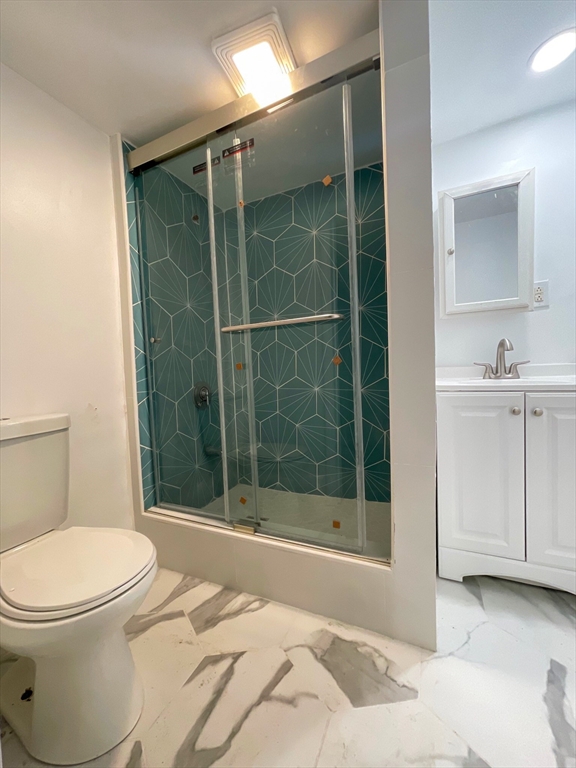 904 Main, Unit 1 Woburn, MA 01801 - Photo 5 of 5 a bathroom with a sink toilet and shower