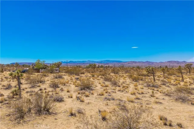 a view of an ocean beach and mountain