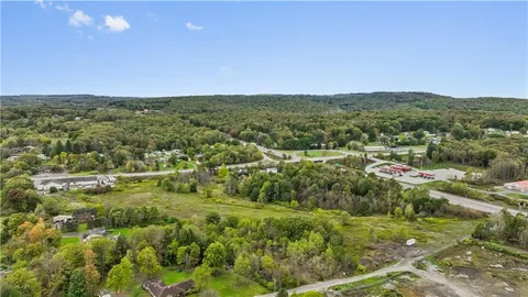 a view of a green field with lots of trees in it
